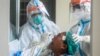 ရန်ကုန်မြို့ရှိ အင်းစိန်မြို့နယ်မှာ COVID ရောဂါ ရှိ၊ မရှိ စစ်ဆေးပေးနေတဲ့ ကျန်းမာရေးဝန်ထမ်းများ။ (စက်တင်ဘာ ၂၁၊ ၂၀၂၀)