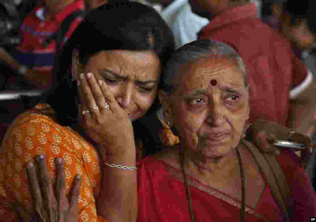 An Indian woman cries as her relative, right who was on pilgrimage in Nepal during Saturday&rsquo;s earthquake, returned at the airport in Ahmadabad, India.