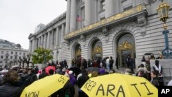 FILE —A crowd listens to speakers at a reparations rally outside of City Hall in San Francisco, on March 14, 2023.