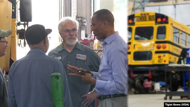 Tashitaa Tufaa chats with mechanics and drivers at Metropolitan Transportation Network’s maintenance shop in Fridley, Minnesota, Aug. 10, 2017.