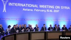 FILE - Participants of Syria peace talks attend a meeting in Astana, Kazakhstan, Feb. 16, 2017. Foreign ministers of Russia, Iran and Turkey are expected to gather in Astana next week to again discuss the deteriorating situation in Syria.
