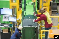 FILE - Workers build washing machines on the assembly line at a Samsung facility in Newberry, South Carolina, March 16, 2018.