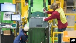 FILE - Workers build washing machines on the assembly line at a Samsung facility in Newberry, South Carolina, March 16, 2018.