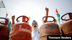 FILE - A farmer shouts slogans during a protest against the hike in fuel prices, at the Delhi-Uttar Pradesh border in Ghaziabad, India, July 8, 2021.