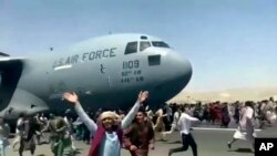 Thousands of Afghans have rushed onto the tarmac of Kabul’s international airport.