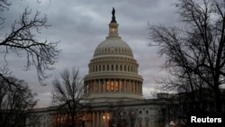 The U.S. Capitol building is lit at dusk ahead of planned votes on tax reform in Washington, Dec. 18, 2017. 