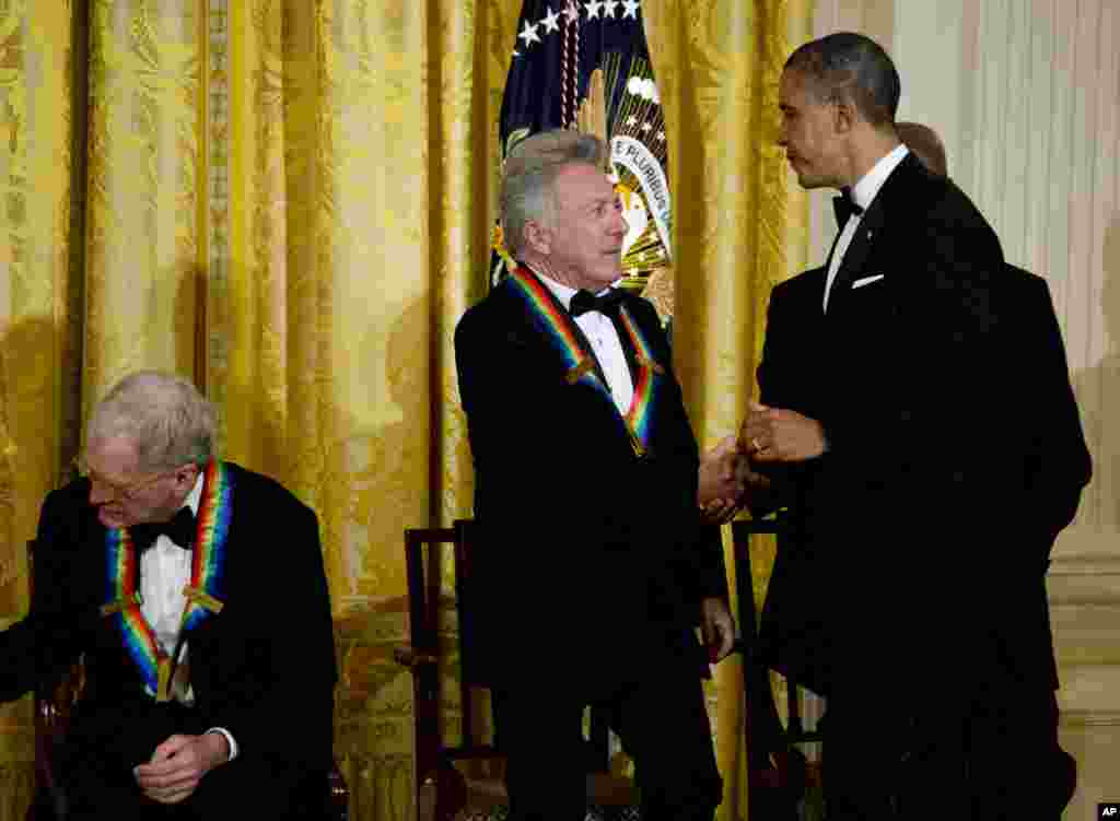 President Barack Obama shakes hands with 2012 Kennedy Center Honors recipient actor and director Dustin Hoffman during a reception for the honorees in the East Room of the White House, December 2, 2012.