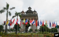 Flags of the 10-member ASEAN (Association of Southeast Asian Nations) and its dialogue partners are placed around the Patuxay Monument in downtown Vientiane, Laos, Sept. 5, 2016.