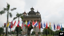 Flags of the 10-member ASEAN (Association of Southeast Asian Nations) and its dialogue partners are placed around the Patuxay Monument in downtown Vientiane, Laos, Sept. 5, 2016. 