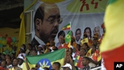 Supporters of the Ethiopian People's Revolutionary Democratic Front (EPRDF) sit in stands under a portrait of Prime Minister Meles Zenawi, Addis Ababa, 20 May 2010