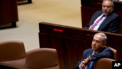 FILE - Israeli Prime Minister Benjamin Netanyahu and former Israeli defense minister Avigdor Liberman sit in the Knesset, Israel's parliament, in Jerusalem, May 23, 2016.