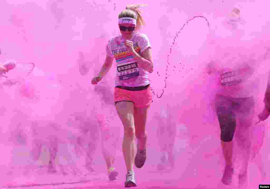 Participants are covered in paint as they take part in the Color Run in London, June 1, 2014.