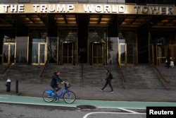 People pass the Trump World Tower in the Manhattan borough of New York, April 30, 2019.