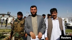 Ziaul Haq Amarkhel, head of Afghanistan's Independent Election Commission, resigned Monday. At center, he's shown leaving a news conference in Kabul June 23, 2014.