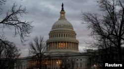 The U.S. Capitol building is lit at dusk ahead of planned votes on tax reform in Washington, Dec. 18, 2017. 