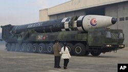 North Korean leader Kim Jong Un, left, and his daughter inspect what it says a Hwasong-17 intercontinental ballistic missile at Pyongyang International Airport in Pyongyang, North Korea, Nov. 18, 2022. Photo provided by the North Korean government, Nov. 1