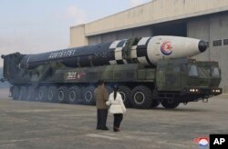 North Korean leader Kim Jong Un, left, and his daughter inspect what North Korea says a Hwasong-17 intercontinental ballistic missile at Pyongyang International Airport in Pyongyang, Nov. 18, 2022. (Korean Central News Agency/Korea News Service via AP)