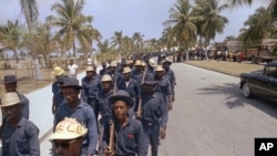 FILE - Tonton Macoutes march in downtown Port-au-Prince in support of Haiti's President Francois Duvalier, April 27, 1970.