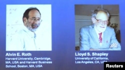 Pictures of U.S. economists Alvin Roth and Lloyd Shapley, who won the 2012 Nobel prize for economics, are seen projected at the Swedish Royal Academy of Sciences in Stockholm, Sweden, October 15, 2012. 