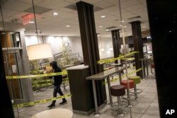 A man walks out of a McDonald's restaurant with his bag of food in the Brooklyn borough of New York, where the seating area has been cordoned off to its customers and only take out is available, March 18, 2020.