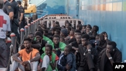 FILE - Migrants disembark from the Taburiente ship of the Naviera Armas at the Port of Los Cristianos, island of Tenerife, Spain, on October 12, 2023. Migrants have been transferred to Tenerife as the number of arrivals to the archipelago has spiked.