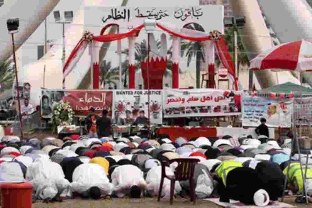 Anti-government protesters participate during midday prayers at the Pearl roundabout in Manama, Bahrain, February 25, 2011