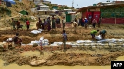 Rohingya refugees make a drainage canal in preparation for the upcoming monsoon season in Kutupalong refugee camp in Ukhia, Bangladesh, May 8, 2018.