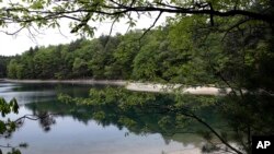 FILE - This photo taken May 23, 2017, shows a view of Walden Pond in Concord, Mass., where the 19th-century American philosopher and naturalist Henry David Thoreau spent two years in solitude and reflection. A new Playstation game devoted to the Thoreau classic was set for its debut May 15, 2018.