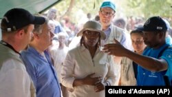 WFP Executive Director Ertharin Cousin, center, previously visited South Sudan in April 2014. Cousin is shown during a visit to a food distribution center in Nyal, Unity state, with the U.N. High Commissioner for Refugees, Antonio Guterres, center-left. 