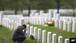 Former Marine Adam Furr visits the grave of his friend Marine Lt. Col. Kevin Michael Shea at Arlington National Cemetery in Arlington, Virginia, Monday, May 2, 2011. "It doesn't seem like it's in vain anymore" said Furr, who decided to visit after the dea