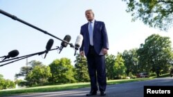 U.S. President Donald Trump talks to reporters as he departs for the Camp David, Md., presidential retreat from the South Lawn of the White House in Washington, May 15, 2020. 