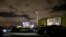 FILE - People inside their cars watch a movie at a drive-in theater while keeping social distancing rules amid the coronavirus pandemic, in Fort Lauderdale, Florida, March 28, 2020.