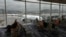 FILE - Travelers wait at a departure area as an aircraft operated by Cathay Pacific Airways taxis at Hong Kong International Airport, in Hong Kong, Oct. 8, 2023.