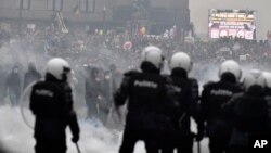 FILE - Police set off a water cannons against protesters during a demonstration against COVID-19 measures in Brussels, Belgium, Jan. 23, 2022.