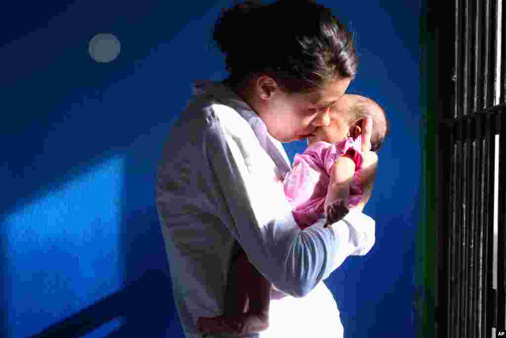 Heather Mack of Chicago, Illinois, carries her baby inside a cell after her verdict at her trial in Bali, Indonesia. The Denpasar District Court sentenced Tommy Schaefer to 18 years in prison and Heather Mack to 10 years for intentionally killing Sheila von Wiese-Mack while vacationing last August.