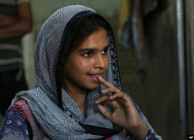 In this April 14, 2019 photo, Muqadas Ashraf speaks to The Associated Press in Gujranwala, Pakistan. Muqadas Ashraf was just 16 when her parents married her off to a Chinese man who had come to Pakistan looking for a bride.