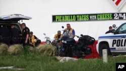 FILE - Police detain members of two motorcycle gangs after a shootout at Twin Peaks restaurant in Waco, Texas, May 17, 2015.
