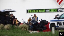 Police detain and watch members of various motorcycle clubs near a Twin Peaks restaurant in Waco, Texas, Sunday, May 17, 2015.
