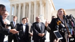 FILE - Samsung's counsel of record Kathleen M. Sullivan (R) answers questions from the media outside the U.S. Supreme Court following oral arguments on Oct. 11, 2016 in Washington in this photo distributed by Samsung.
