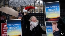 Pro-Brexit demonstrators celebrate outside Parliament in London, Dec. 20, 2019.