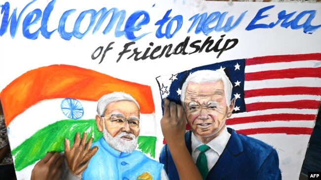 Estudiantes dan los toques finales a una pintura del primer ministro de la India, Narendra Modi, y del presidente estadounidense, Joe Biden, en una escuela de arte en Mumbai el 7 de septiembre de 2023, antes de la cumbre del G20 de dos días en Nueva Delhi. 