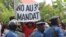 A protester holds a placard at a rally opposing Burundi President Pierre Nkurunziza's bid for a third five-year term in office, in Bujumbura, May 4, 2015.