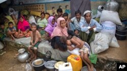 Rohingya Muslims, who crossed over from Myanmar into Bangladesh, rest inside a school compound at Kutupalong refugee camp, Bangladesh, Monday, Oct. 23, 2017. 