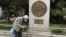 A man makes his way past a replica of a one drachma coin outside the Athens Town Hall, May 21, 2012.