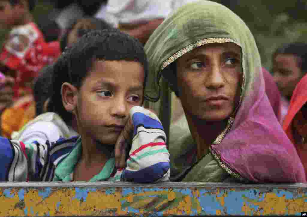 Indian villagers sit in a tractor as they flee their homes fearing firing from the Pakistan side of the border at Chilyari village of Samba sector in Jammu and Kashmir state.