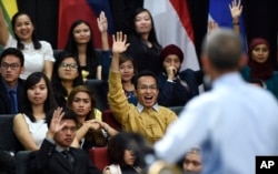 Audience members raise their hands in hopes of asking U.S. President Barack Obama a question as he speaks at the Young Southeast Asian Leaders Initiative (YSEALI) town hall at Taylor's University in Kuala Lumpur, Malaysia, Nov. 20, 2015.