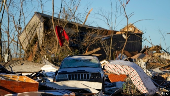 Damaged cars and destroyed homes are seen in the aftermath of tornadoes that tore through the region, in Mayfield, Ky., Monday, Dec. 13, 2021.