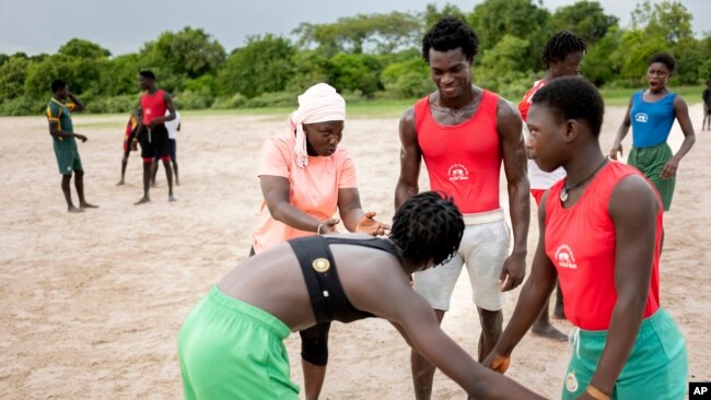 SenegaCoach Isabelle Sambou, 43 years old, two-time Olympian and nine-time African wrestling champion, left, speaks to young women during a wrestling training in Mlomp, southern Senegal, July 10, 2024.