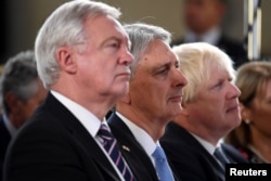 (L-R) David Davies Secretary of State for Exiting the European Union, Chancellor of the Exchequer Philip Hammond and Foreign Secretary Boris Johnson listen Britain's Prime Minister Theresa May as she gives a speech in Complesso Santa Maria Novella, Floren