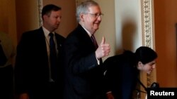 U.S. Senate Majority Leader Mitch McConnell (R-KY) gestures to reporters after lawmakers struck a deal to reopen the federal government three days into a shutdown on Capitol Hill in Washington, Jan. 22, 2018. 